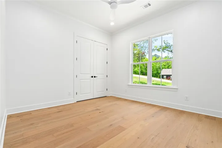 Bedroom 2 is positioned at the front of the home and offers direct access to the Jack-and-Jill bath.