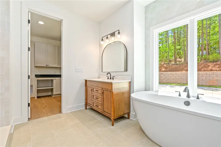 Positioned for both privacy and function, the primary suite offers direct access to the laundry room.