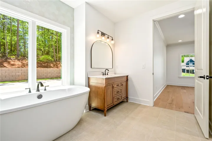 Dual vanities flanking a soaking tub create a well-balanced, comfortable retreat.