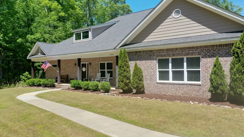 This classic residence features a classic brick exterior and a welcoming covered porch.