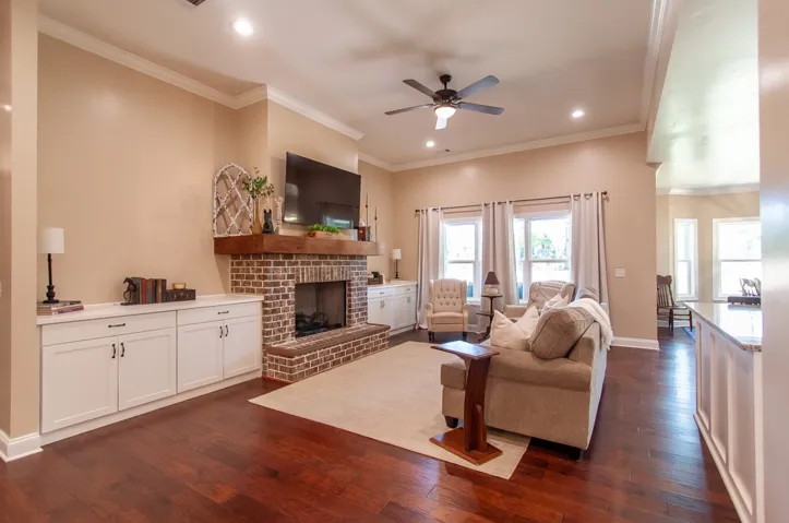 This inviting living space features rich hardwood floors and a cozy fireplace, perfect for gatherings.