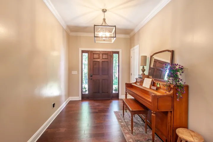 Step inside this inviting entry with hardwood floors and crown molding.