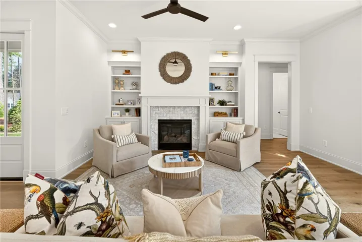 This inviting living space features a cozy fireplace and built-in shelving, perfect for relaxation.