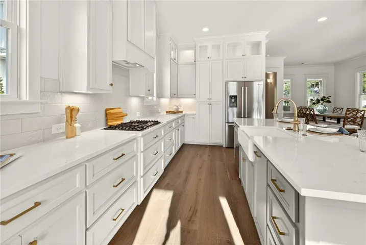 This bright kitchen features sleek Bosch appliances and ample counter space, perfect for culinary endeavors.