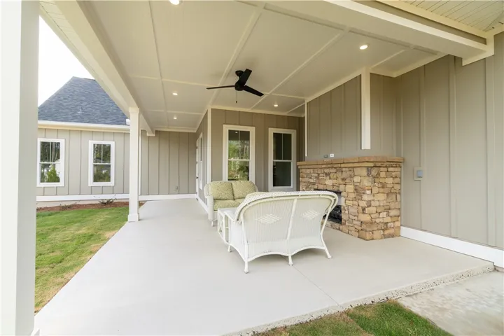 Rear Porch W/ Stone Fireplace + Grilling Pad perfect for outdoor enjoyment!