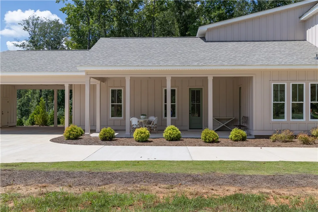 Attached 2 Car Carport W/ Golf Cart Parking Pad & Outside Storage!