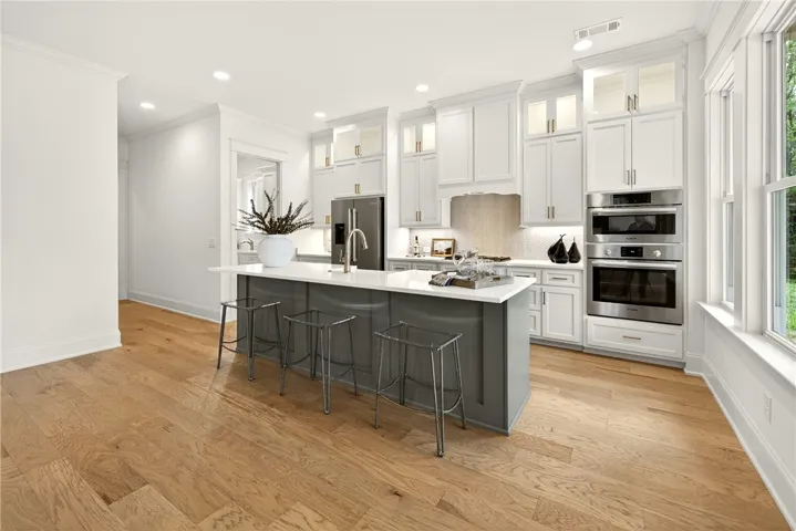 Kitchen Island W/ Farmhouse Sink & Quartz Countertops. Upper cabinetry extends to ceiling w/ luminous glass front doors perfect for showcasing collectibles or dinnerware.