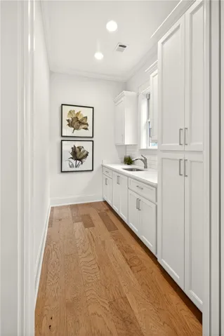 Butler's Pantry/Prep Kitchen includes pantry w/ roll out shelving, ample counterspace & additional sink for easy clean up. Additional storage is offered in the upper & lower cabinetry!