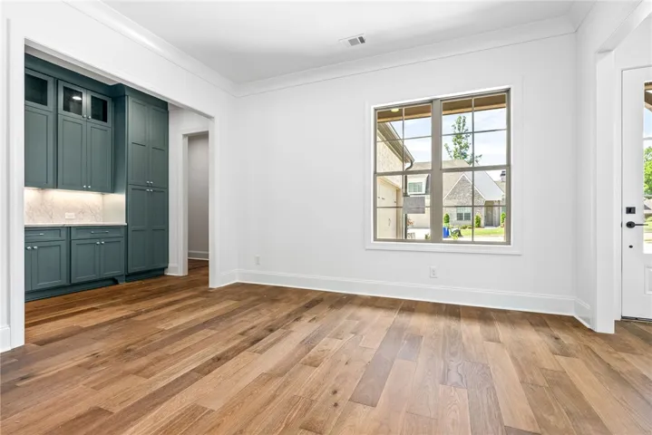 The dining room is located on the front of the house, between the kitchen and great room. *Chandelier is coming soon.