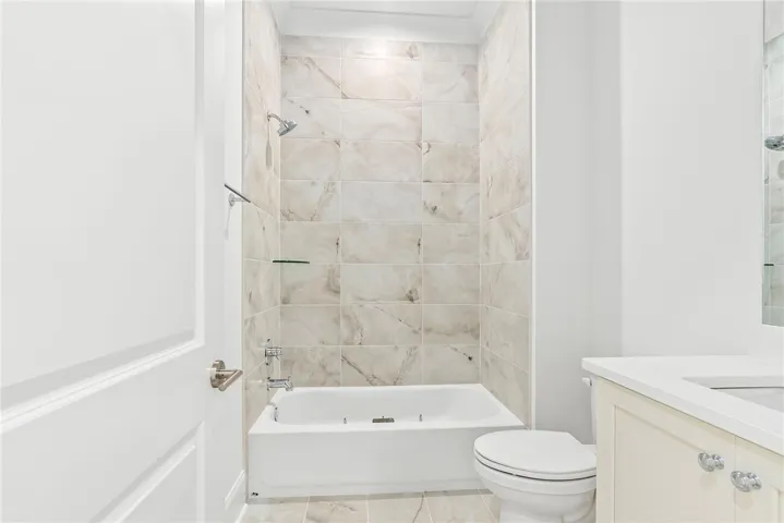 Floor-to-ceiling tile in Bath 2 adds a polished, custom touch.