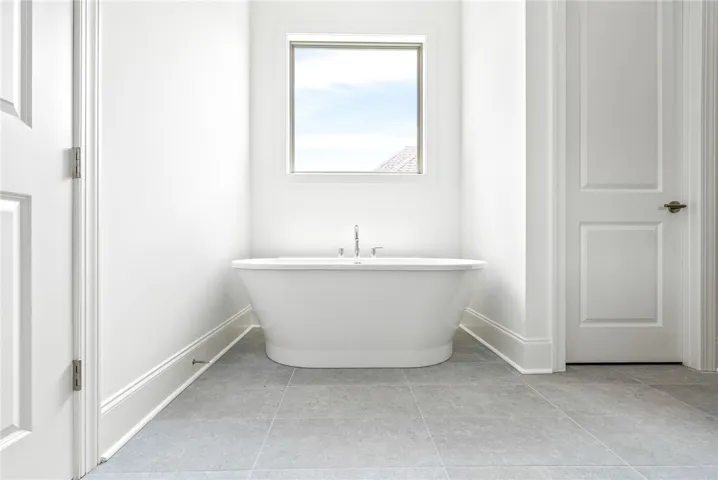 The primary bathroom offers a soaking tub, as well as a step-in shower.