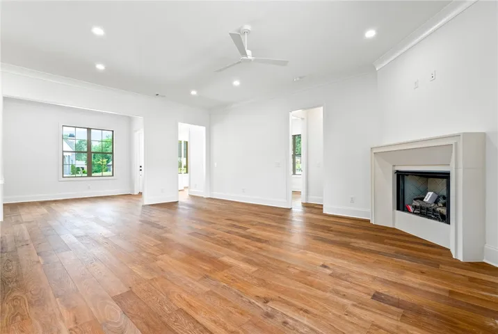 The great room and kitchen separate the primary bedroom wing from the secondary bedroom wing.