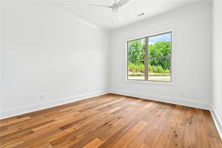 The secondary bedrooms on the main level feature hardwood floors.