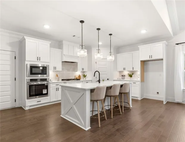 This bright kitchen features an island, ample counter space, and modern appliances.