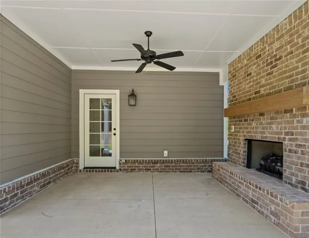 This inviting patio features a brick fireplace, offering a perfect outdoor retreat for relaxation and entertainment.