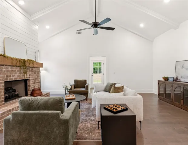 This airy living area features a grand fireplace and vaulted ceilings.