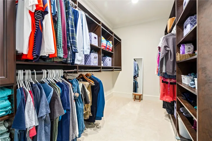 Ample closet space with built-in organization, offering both hanging rods and shelving.
