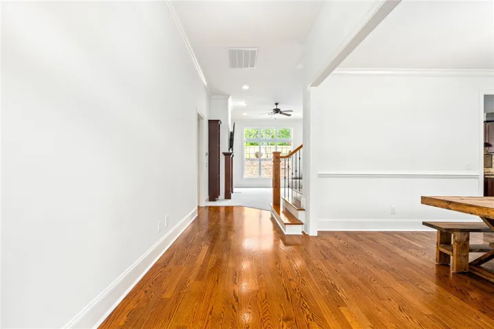 This inviting home features gleaming hardwood floors and classic crown molding, perfect for modern living.