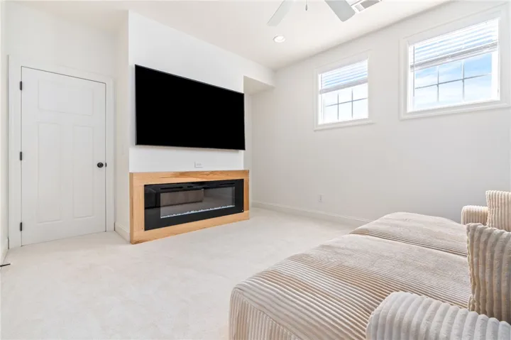 This versatile living space features a cozy fireplace, perfect for intimate gatherings.