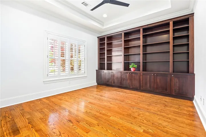 This versatile room features custom built-ins and hardwood floors, ready for your personal touch.