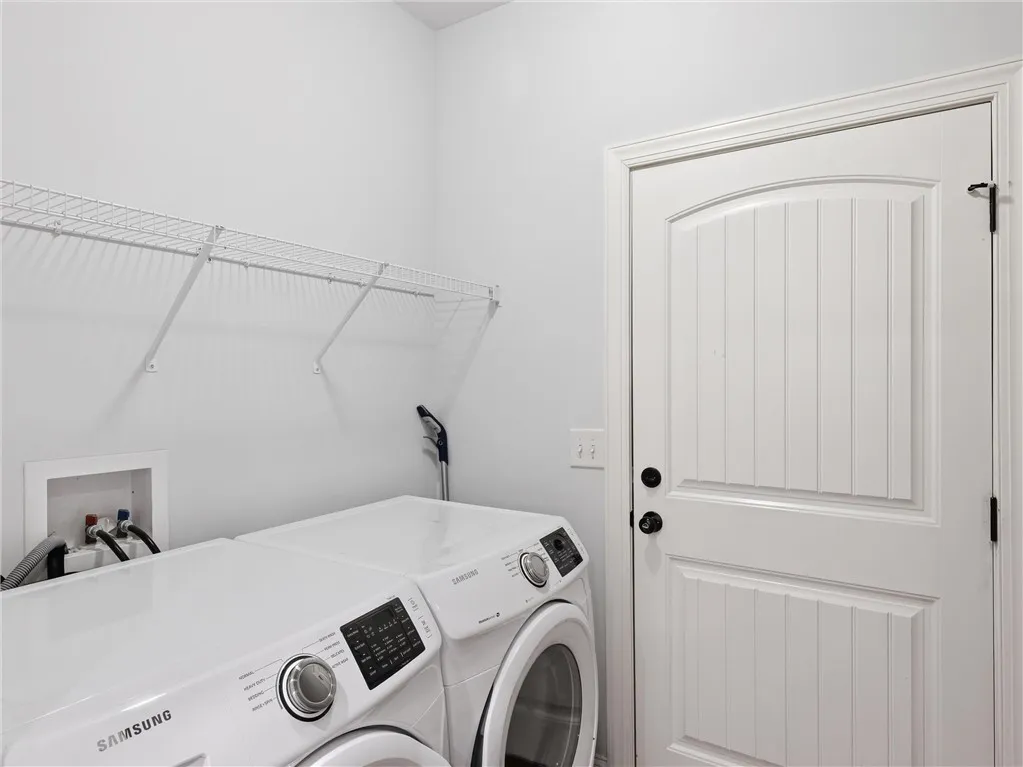 This laundry area features convenient appliances and functional storage solutions.
