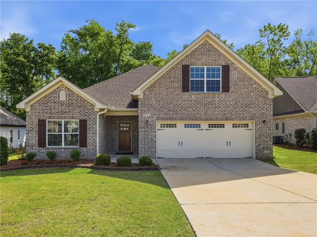 This charming residence features classic brick construction and a well-maintained lawn.