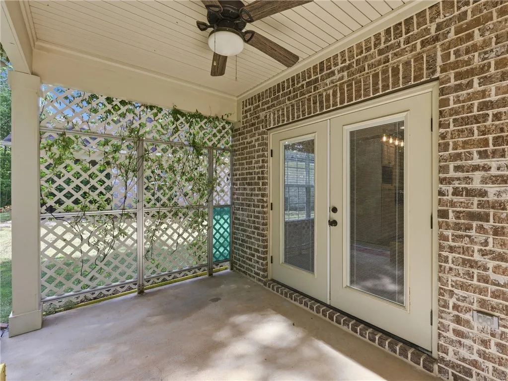 Enjoy outdoor living with this inviting patio featuring brick and lattice details.