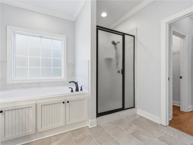 Relax and refresh in this tranquil bathroom, offering a shower and soaking tub.