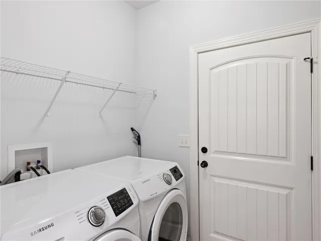 This laundry area features convenient appliances and functional storage solutions.