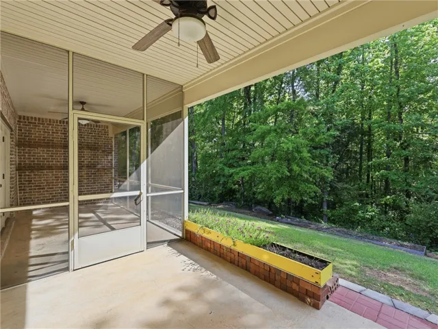 This serene screened porch provides an inviting escape into nature.
