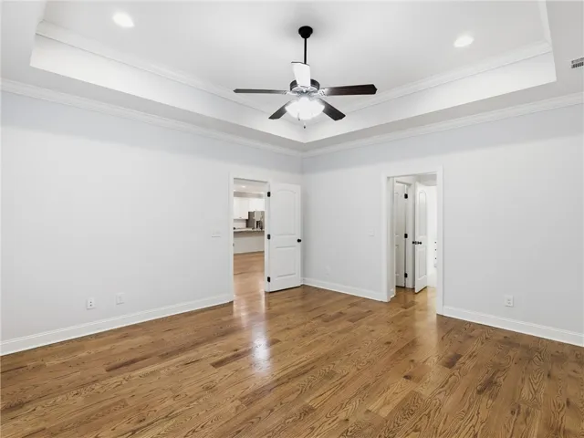 This spacious room features elegant hardwood flooring and a stylish tray ceiling.