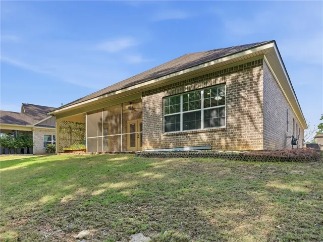 This residence features a screened porch and a brick exterior, offering comfortable outdoor living.