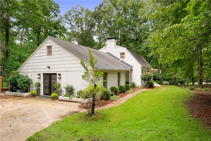 This charming home features a well-manicured yard and mature trees, offering a private oasis.