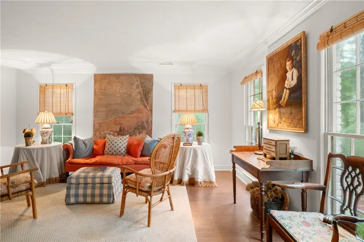 This living area features ample natural light and rich wood flooring, ideal for relaxation.