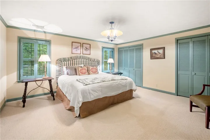 This spacious bedroom offers ample comfort and natural light.