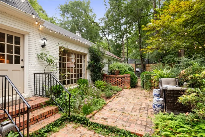 This charming outdoor area offers a private sanctuary with lush landscaping and inviting pathways.