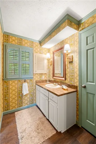 This bathroom features a functional vanity with ample storage and classic flooring.