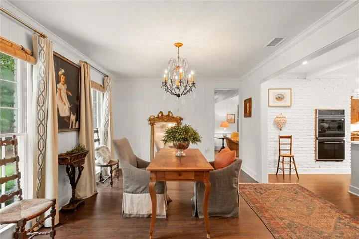 This bright and inviting room boasts gleaming hardwood floors and an elegant chandelier.