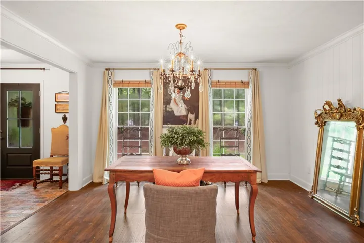 Elegant dining space featuring gleaming hardwood floors and ample natural light.