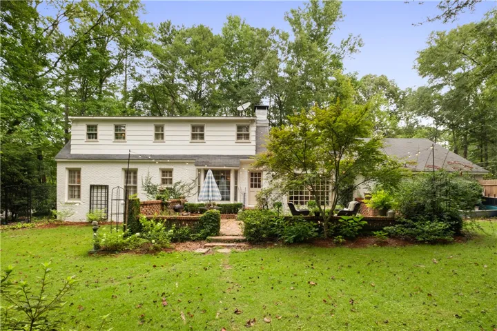 This private yard features a patio area, perfect for enjoying the outdoors amidst lush greenery.