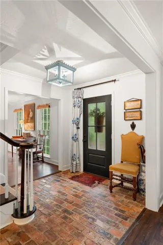 Step into this welcoming entrance foyer featuring traditional brick flooring and elegant finishes.