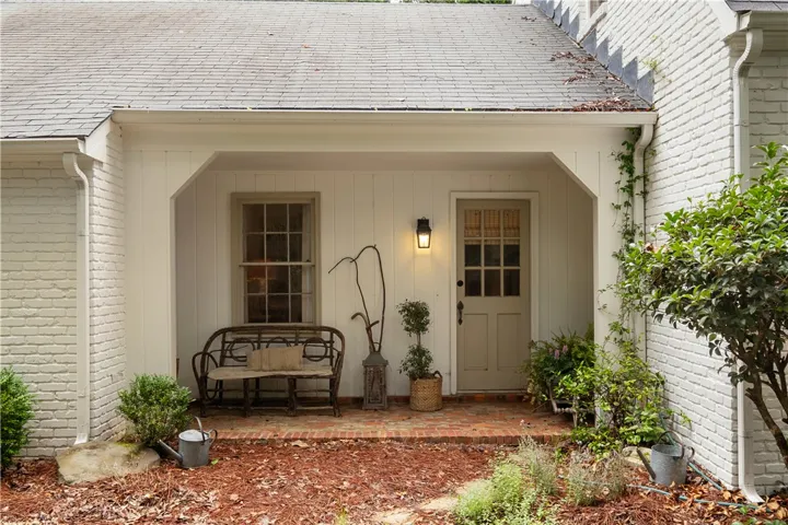 This charming front porch features classic brick flooring and a welcoming entry.