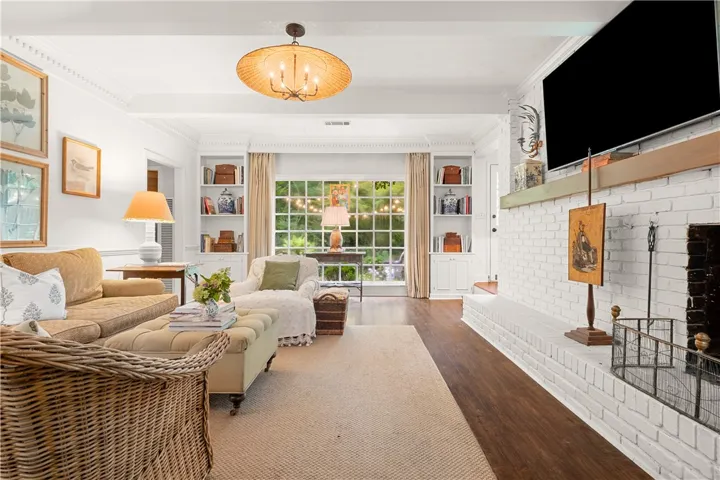 This inviting living space features warm flooring, a cozy fireplace, and abundant natural light.