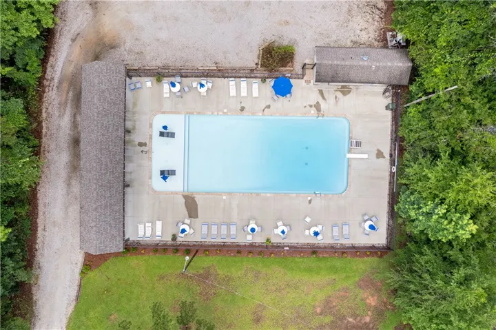 An aerial view reveals a refreshing pool with ample lounging space, inviting relaxation and recreation.