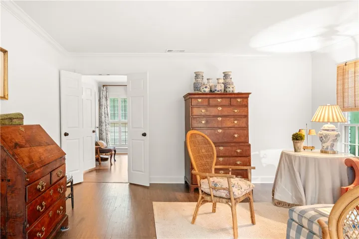 This bright room features warm wood flooring and classic architectural details throughout.