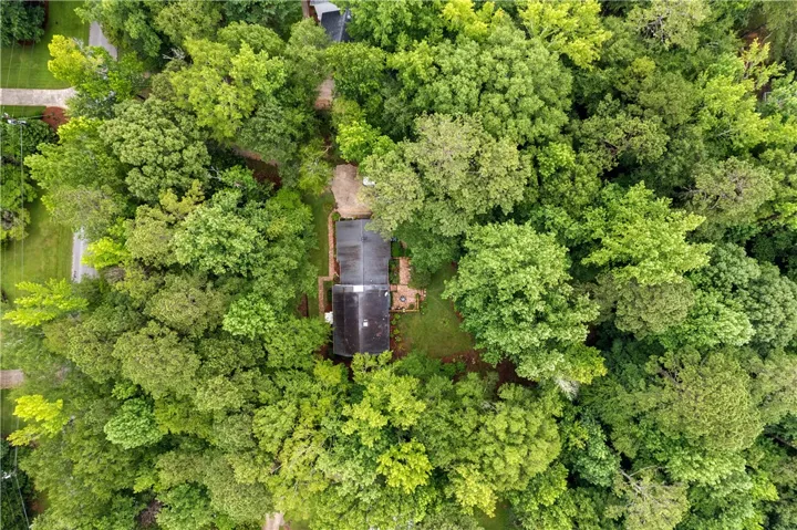 Perched amidst lush greenery, this home offers serene privacy, harmoniously blending with its natural surroundings.