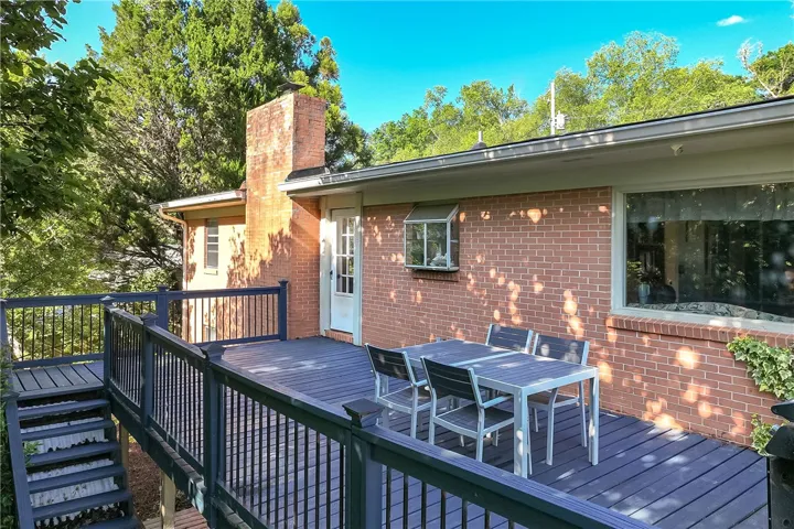 This inviting outdoor space features a spacious deck, perfect for enjoying peaceful moments amidst nature.