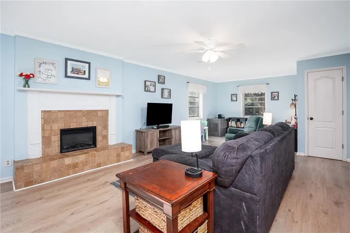 This inviting living area features a warm fireplace and durable flooring, perfect for comfortable gatherings.