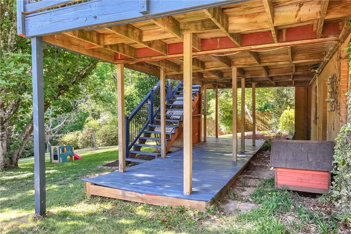 This charming outdoor area features a spacious deck and staircase, offering a perfect spot for relaxation.