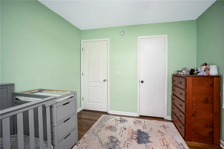 This cozy space features warm wood flooring and ample natural light, perfect for peaceful living.